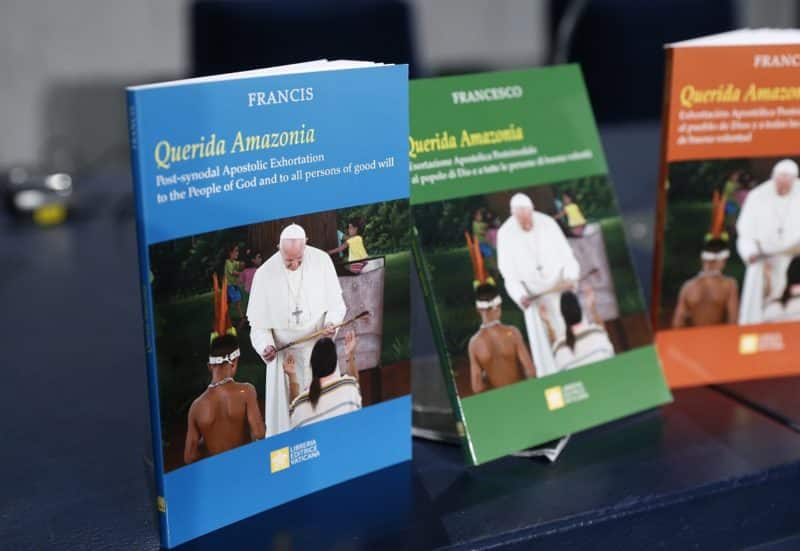 Copies of Pope Francis' apostolic exhortation, "Querida Amazonia" (Beloved Amazonia), are pictured at a news conference for the release of the exhortation at the Vatican Feb. 12, 2020. The document contains the pope's conclusions from the 2019 Synod of Bishops for the Amazon. (CNS photo/Paul Haring) See AMAZON-DOCUMENT, AMAZON-PRIESTS, VATICAN-LETTER-AMAZON-WOMEN, and AMAZON-ACTION Feb. 12, 2020.