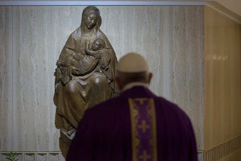 Pope Francis is pictured near a Marian statue as he celebrates morning Mass in the chapel of his residence, the Domus Sanctae Marthae, at the Vatican March 11, 2020. (CNS photo/Vatican Media) See POPE-MASS-PRISONERS March 11, 2020.