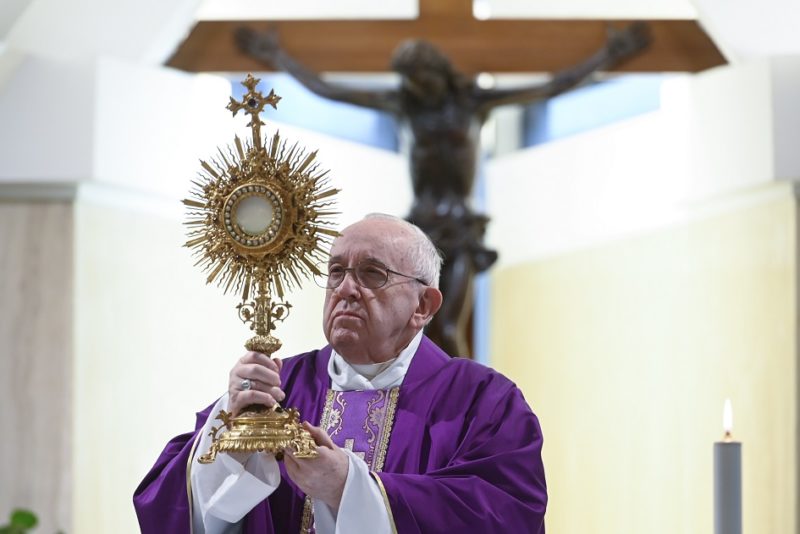 Pope Francis raises the monstrance during eucharistic adoration at the end of Mass March 26, 2020, in the chapel of his Vatican residence, the Domus Sanctae Marthae. About a dozen priests also live in the Vatican guesthouse and news reports March 25 said one of them, an Italian monsignor working in the Vatican Secretariat of State, had tested positive for COVID-19. (CNS photo/Vatican Media) See VATICAN-OFFICIAL-COVID-19 March 26, 2020.