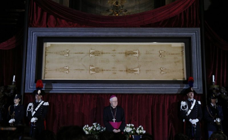 Archbishop Cesare Nosiglia of Turin, Italy, has announced a special live-stream exposition of the Shroud of Turin on Holy Saturday, April 11, at 5 p.m. local time in Turin. Archbishop Nosiglia said he had received "thousands and thousands" of messages asking for the shroud's display as Italy and the world battle the coronavirus. Archbishop Nosiglia is pictured in front of the shroud in the Cathedral of St. John the Baptist in Turin in this April 18, 2015, file photo. (CNS photo/Paul Haring) See TURIN-SHROUD-HOLY-SATURDAY April 5, 2020.