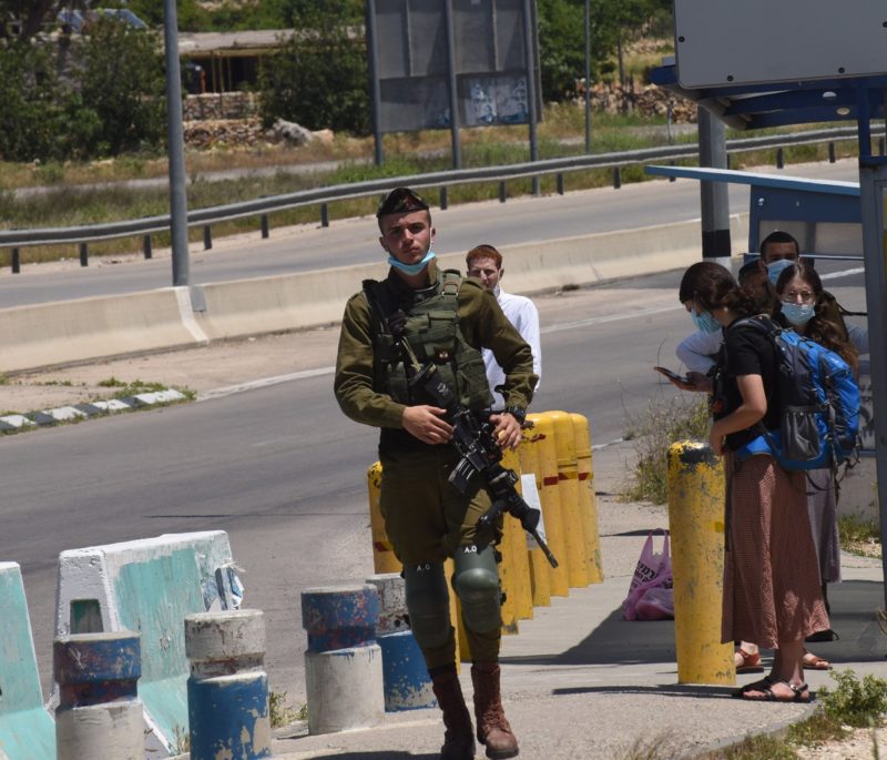 An Israeli soldier guards at the Gush Etzion Settlements junction near Bethlehem, West Bank, May 10, 2020. The Vatican issued a statement May 20 stating concerns about an Israeli plan to unilaterally annex a large portion of land in the West Bank. (CNS photo/Debbie Hill) See VATICAN-ISRAEL-ANNEX May 20, 2020.