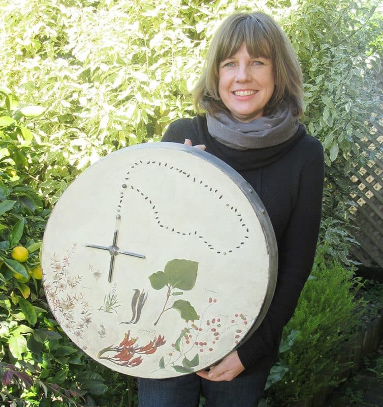Emma Cunningham holds “Parama”, with four plants represented — kawakawa, kareao, manuka and harakeke. The rosary beads are flax seeds set in test tubes.
