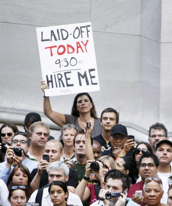 File photo of a woman holding a sign as a crowd gathers outside the historic Federal Hall where U.S. President Barack Obama was speaking in the heart of Wall Street in New York Sept. 14. (CNS photo/Larry Downing, Reuters) (Sept. 14, 2009)