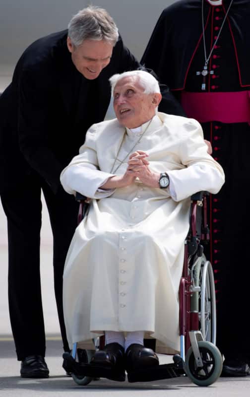 Retired Pope Benedict XVI speaks to his private secretary, Archbishop Georg Ganswein, at Germany's Munich Airport before his departure to Rome June 22, 2020. An author with a long and close relationship to Pope Benedict told a German newspaper that the 93-year-old retired pope is "extremely frail." (CNS photo/Sven Hoppe, pool via Reuters) See BENEDICT-SEEWALD Aug. 3, 2020.