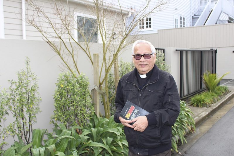 Fr Andrew Nguyen Huu Le with his book
