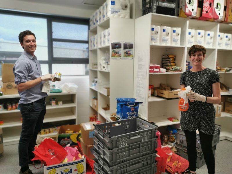 Tania Martin (social worker) and David (volunteer) cleaning incoming purchases for the food bank in Wellington.
