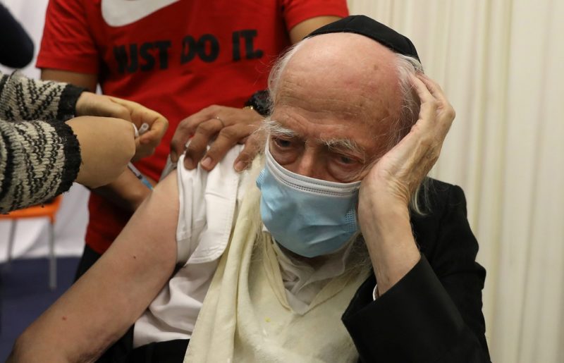 A health care worker vaccinates an elderly man against COVID-19 in Jerusalem Dec. 21, 2020. The Vatican's doctrinal office said it is morally acceptable to receive COVID-19 vaccines using cell lines originating from aborted fetuses when alternative vaccines  are not made available. (CNS photo/Ammar Awad, Reuters)