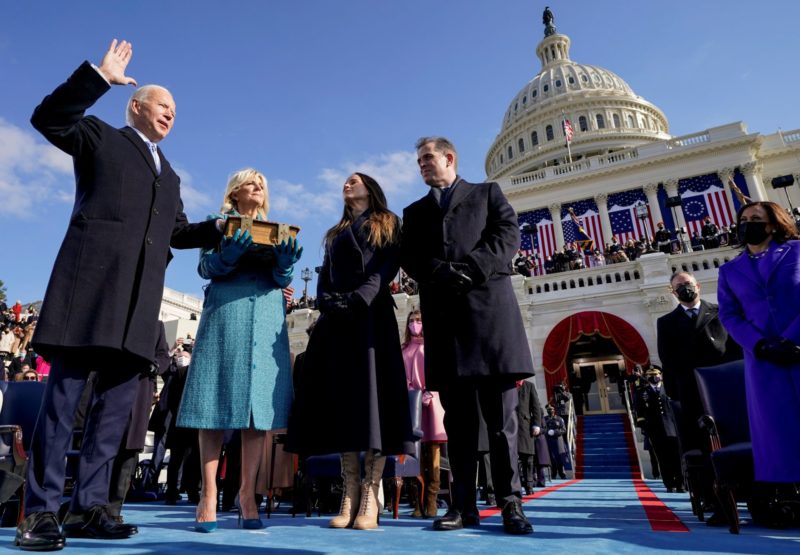 Joe Biden is sworn in as the 46th president of the United States by Chief Justice John Roberts as Biden's wife, Jill, holds the family Bible during his inauguration at the Capitol in Washington Jan. 20, 2021. (CNS photo/Andrew Harnik, pool via Reuters)