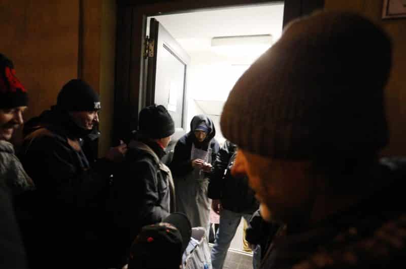 A Missionaries of Charity nun stands in the doorway as men enter a center run by the order for an evening meal at the Vatican in this Jan. 7, 2017, file photo. Two cardinals, an archbishop and a dozen priests concelebrated a funeral Mass Jan. 25 for Roberto Mantovani, who spent much of the past few years living on the streets near the Vatican. (CNS photo/Paul Haring)