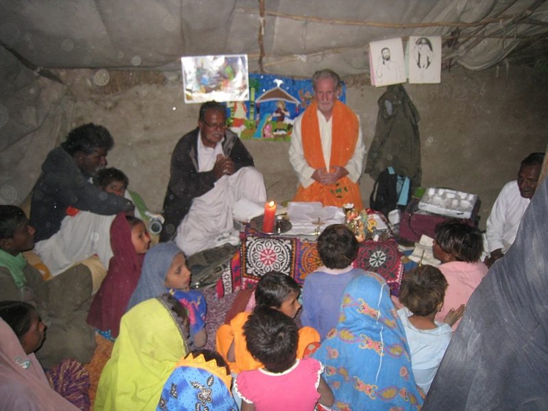 Kiwi Fr Daniel O’Connor, SSC, celebrates Mass at Christmas with a family inside a donated tent that is their home after flooding.
