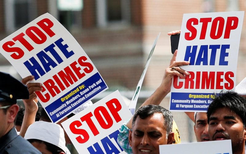 Demonstrators hold "Stop Hate Crimes" signs. (CNS photo/Eduardo Munoz, Reuters)