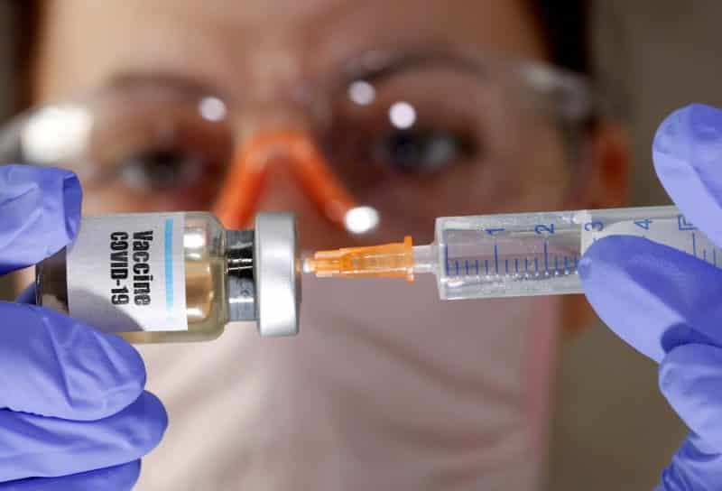 A woman holds a small bottle labeled "Vaccine COVID-19" in this illustration photo. (CNS photo/Dado Ruvic, Reuters)