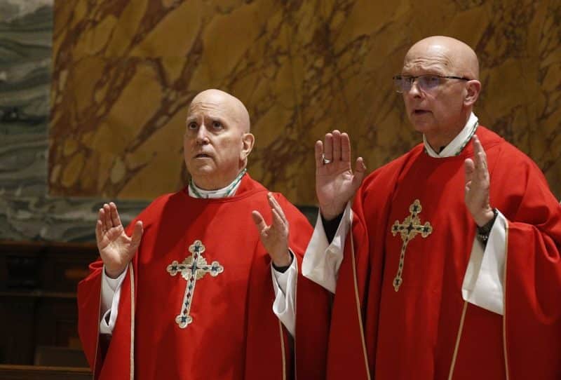 Archbishop Samuel J. Aquila of Denver, and Bishop James S. Wall of Gallup, N.M., pray the Lord's Prayer as bishops from Arizona, Colorado, New Mexico, Utah and Wyoming concelebrate Mass at the Basilica of St. Paul Outside the Walls in Rome Feb. 12, 2020. (CNS photo/Paul Haring)