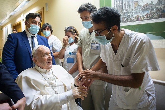 Pope Francis gives a rosary to a member of the medical staff at Gemelli hospital in Rome July 11, 2021, as he recovers following scheduled colon surgery. Earlier the pope led the Angelus from a balcony at the hospital. (CNS photo/Vatican Media via Reuters)