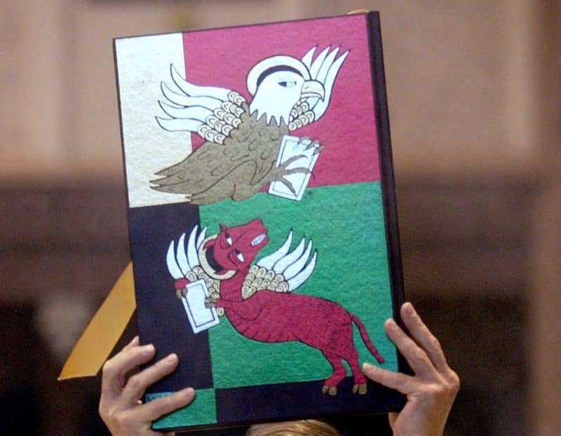 Deacon Gregory Fabian carries the lectionary during a Mass of ordination for new deacons at Holy Angels Cathedral in Gary, Ind., in early June. (CNS photo by Karen Callaway, Northwest Indiana Catholic) (Aug. 5, 2003) See DEACONS Aug. 5, 2003.