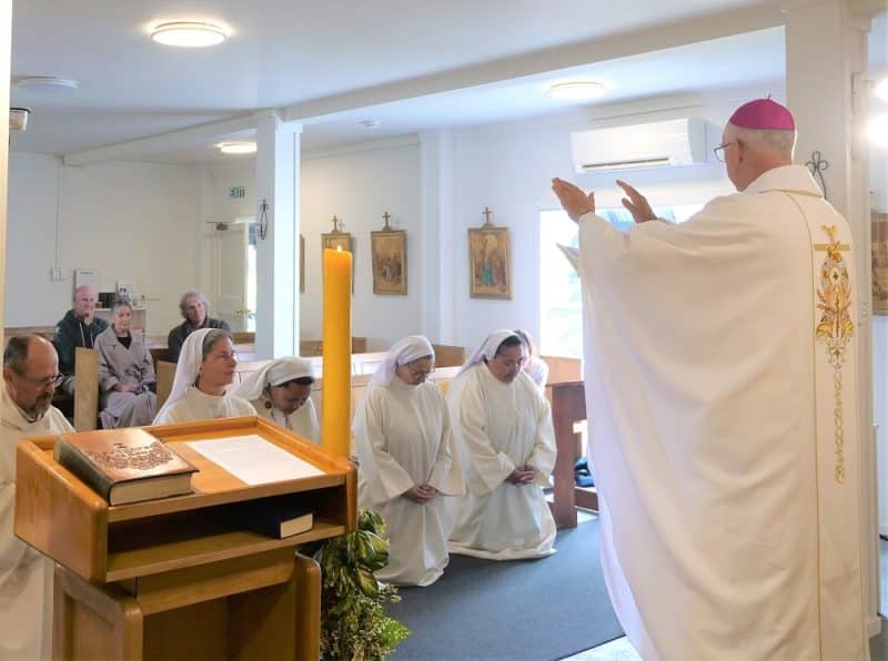  Archbishop Paul Martin prays at the Mass.