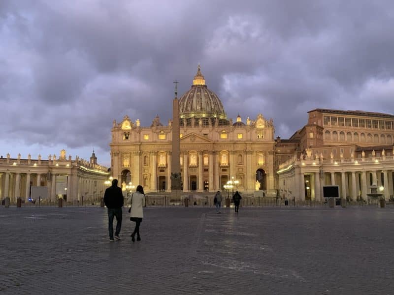 A couple walks toward St. Peter's Basilica at the Vatican in this Feb. 18, 2020, photo. Until the Vatican issued new rules, visitors to the basilica in the early morning could find several priests celebrating private Masses at side altars. (CNS photo/Cindy Wooden)