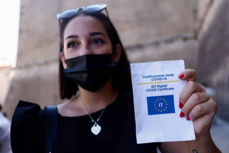 A woman shows her Green Pass, signifying vaccination against COVID-19 or a negative test taken within 48 hours, before entering the Vatican Museums at the Vatican in this Aug. 6, 2021, file photo. Beginning Oct. 1 the Vatican will require proof of vaccination or a negative COVID test from most people wanting to enter Vatican territory or offices. People attending Vatican liturgies are exempt from the requirements. (CNS photo/Guglielmo Mangiapane, Reuters)