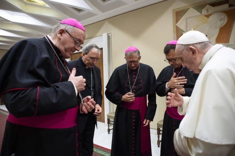 Pope Francis and four French bishops make the sign of the cross during silent prayer for the victims of abuses committed by members of the clergy, prior to the pope's general audience at the Vatican Oct. 6, 2021. The bishops were visiting Rome following a report on sexual abuse in France that estimates more than 200,000 children were abused by priests since 1950, and more than 100,000 others were abused by lay employees of church institutions. (CNS photo/Vatican Media)