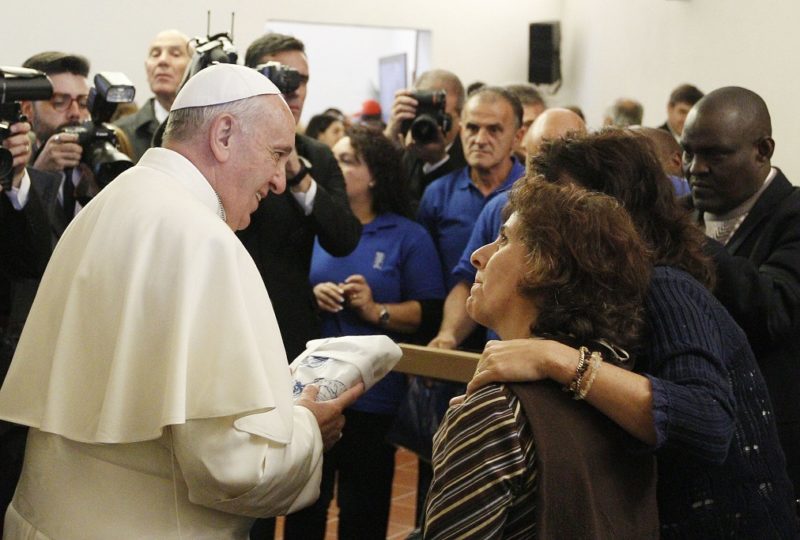Pope Francis greets people during a meeting with the poor in the  archbishop's residence in Assisi, Italy, in this Oct. 4, 2013, file photo. The pope will travel to Assisi Nov. 12 for a time of listening and prayer with 500 poor people from several countries. (CNS photo/Paul Haring)