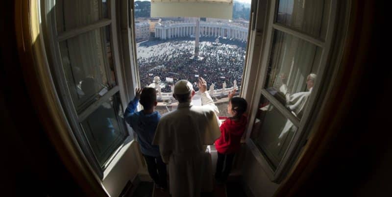 Pope Francis and young people associated with Catholic Action, a lay apostolate, wave as the pope leads the Angelus from his studio overlooking St. Peter's Square at the Vatican Jan. 29. (CNS photo/L'Osservatore Romano, handout)