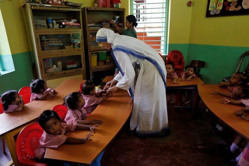 A member of the Missionaries of Charity interacts with the children of a kindergarten inside the Nirmala Shishu Bhavan, a home for orphaned, destitute and abandoned children in Kolkata, India, Aug. 30, 2016. The congregation has been forced to shut an orphanage in Uttar Pradesh state, after its lease expired. (CNS photo/Rupak De Chowdhuri, Reuters)