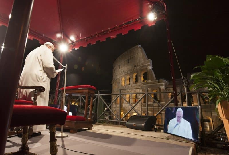 Pope Francis speaks during the Way of the Cross outside the ancient Colosseum in Rome in this March 25, 2016, file photo. The pope has asked several families to write the meditations for his 2022 Way of the Cross service at the Colosseum on Good Friday. (CNS photo/Paul Haring)