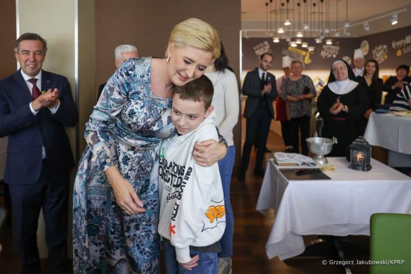 Polish first lady Agata Kornhauser-Duda embraces a boy during an Easter breakfast for Ukrainian refugees in Warsaw, Poland, April 24, 2022. The breakfast was organized by Caritas Poland, Polish Hotel Holding and other Polish hotels for more than 20,000 people from Ukraine. (CNS photo/courtesy Polish Presidency)