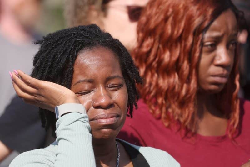 A mourner in Buffalo, N.Y., reacts while attending a May 15, 2022, vigil for victims of the shooting a day earlier at a TOPS supermarket. Authorities say the mass shooting that left 10 people dead was racially motivated. (CNS photo/Brendan McDermid, Reuters)