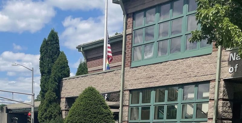 The rainbow gay pride flag and Black Lives Matter flag fly below the American flag at Nativity School of Worcester, Mass., June 14, 2022. (CNS photo/Maria LeDoux, The Catholic Free Press)