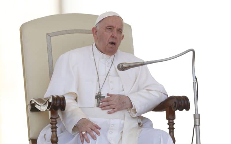 Pope Francis touches his knee during his general audience in St. Peter's Square at the Vatican in this June 1, 2022, file photo. On his doctors' advice because of ongoing problems with his knee, the pope will not travel to Congo and South Sudan in early July, the Vatican announced June 10. (CNS photo/Paul Haring)