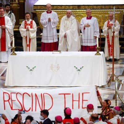 Raising banner, protesters at papal Mass raise questions about ‘Doctrine of Discovery’
