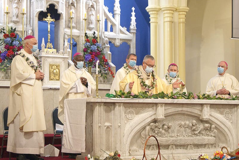 Cardinal John Dew prays at the altar, with (from left) Archbishop Paul Martin, SM, Archbishop Novatus Rugambwa, Bishop Stephen Lowe, Bishop Michael Gielen and Bishop Michael Dooley 