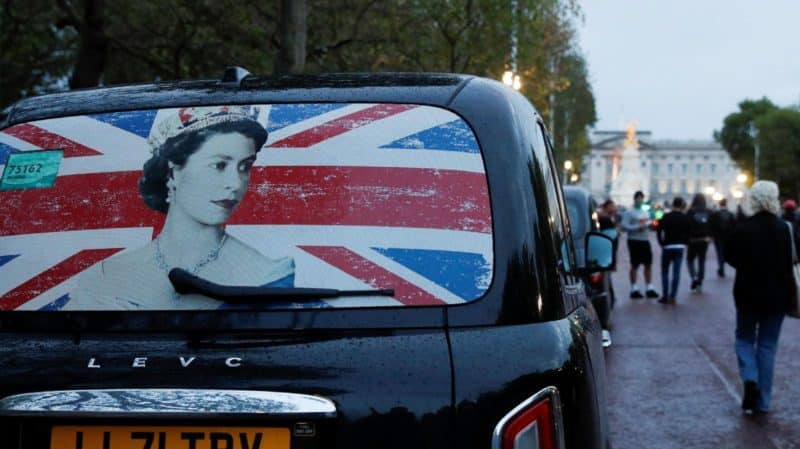 The rear window of a cab with the image of Queen Elizabeth II is pictured parked near Buckingham Palace in London Sept. 8, 2022, as people gather after the announcement that Britain's longest-reigning monarch and the nation's figurehead for seven decades died at the age of 96. (CNS photo/Peter Nicholls, Reuters)