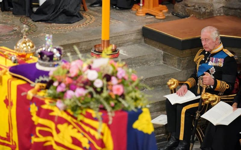 King Charles III sits in front of the coffin of his mother, Queen Elizabeth II, during her state funeral at Westminster Abbey in London Sept. 19, 2022. (CNS photo/Dominic Lipinski, pool via Reuters)
