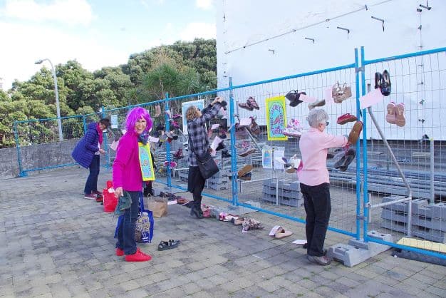 Shoes are placed on a fence in Wellington