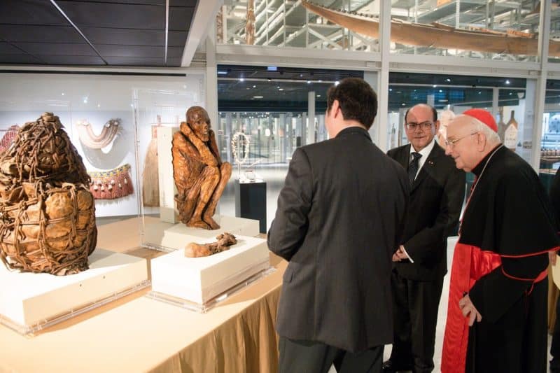 Peruvian Foreign Minister César Landa Arroyo, center, and Cardinal Fernando Vérgez Alzaga, president of the Pontifical Commission for Vatican City State, look at the mummies that will be returned to Peru. The two signed a formal agreement for the mummies' repatriation Oct. 17, 2022, in the Vatican Museums. (CNS photo/Vatican Media)