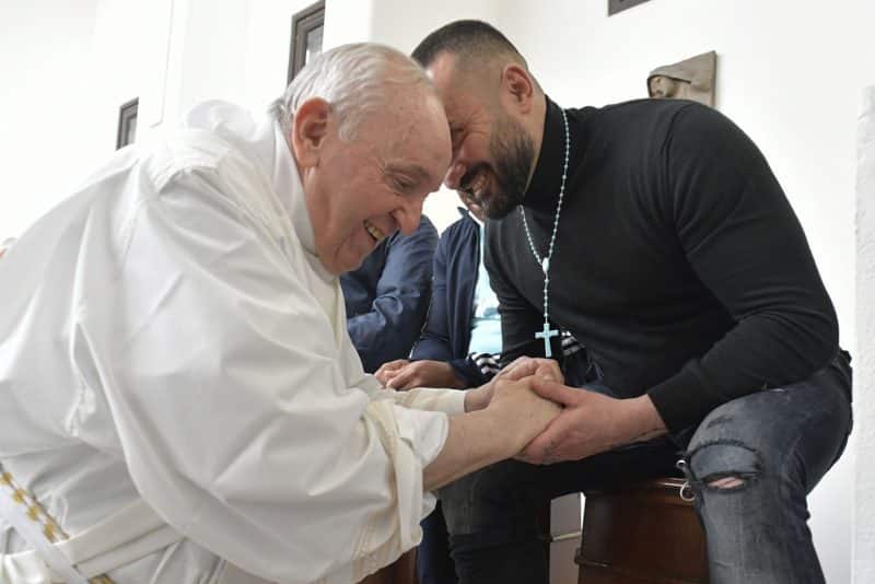 Pope Francis greets an inmate as he washes the feet of prisoners during the Holy Thursday Mass of the Lord's Supper at a prison in Civitavecchia, Italy, April 14, 2022. (CNS photo/Vatican Media)