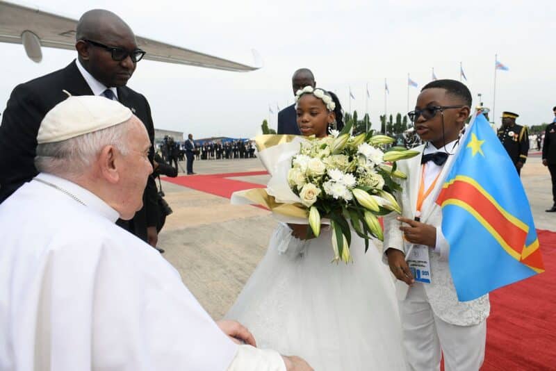 Pope Francis greets children as he arrives at the international airport in Kinshasa, Congo, Jan. 31, 2023. (OSV News photo/Vatican Media vis Reuters)
