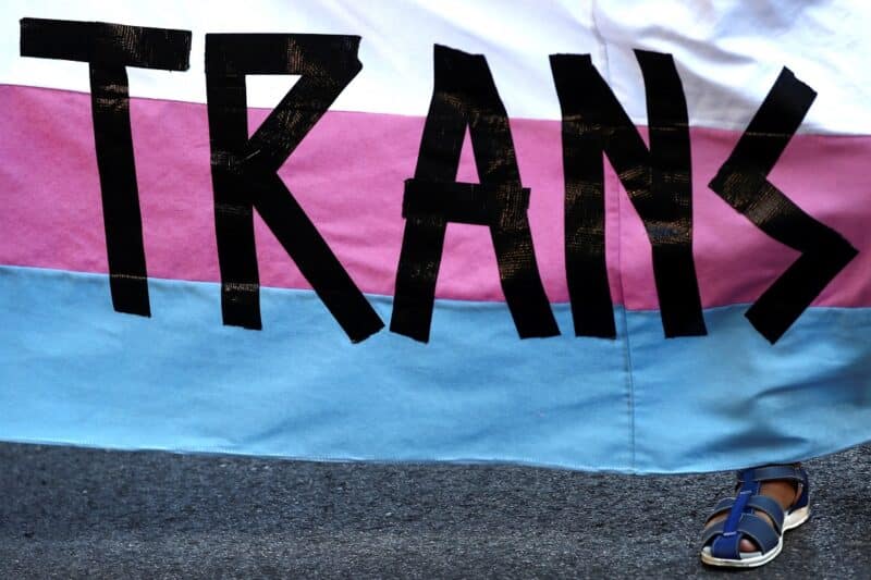 A person holds a "Trans" banner in this illustration photo. Women religious communities representing over 6,000 vowed Catholic religious and partners in mission in over 18 states released a statement for March 31, 2023, also known as International Day of Transgender Visibility. (OSV News photo/Sergio Perez, Reuters)