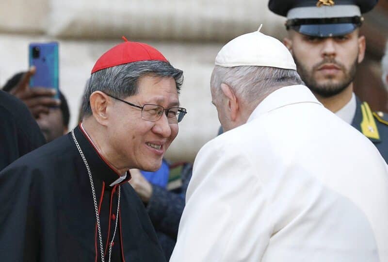 Pope Francis talks with Cardinal Luis Antonio Tagle after praying in front of a Marian statue at the Spanish Steps in Rome Dec. 8, 2022, the feast of the Immaculate Conception. (CNS photo/Paul Haring)