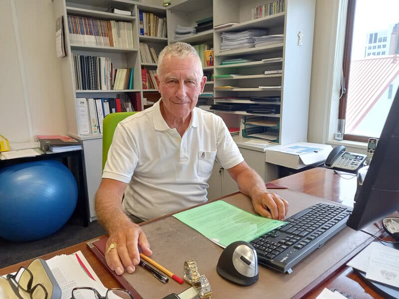 Cardinal John Dew at his desk.