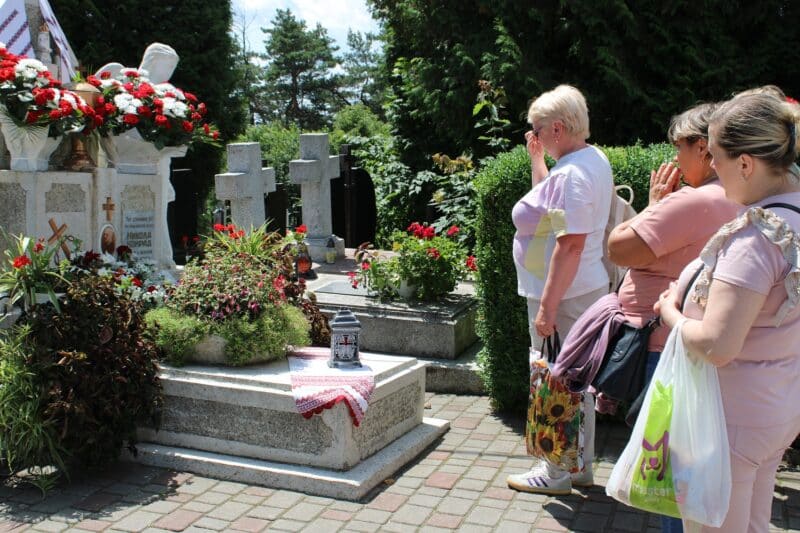 Pilgrims venerate the tomb of Father Mykola Konrad, who was martyred by Soviet troops in 1941, following a Divine Liturgy June 26, 2023, that drew thousands to a Marian spiritual center in Stradch in the Lviv region of Ukraine. (OSV News photo/Gina Christian)