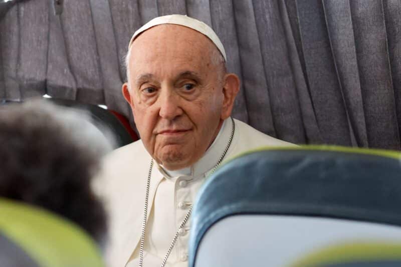 Pope Francis listens to a question from a journalist aboard his flight back to Rome from Lisbon, Portugal, Aug. 6, 2023, after his participation in World Youth Day. (CNS photo/Lola Gomez)