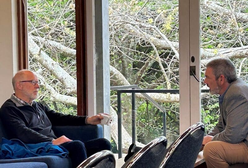 Emeritus Professor William Wilson (left) discusses science and religious faith with Cy Kellett.