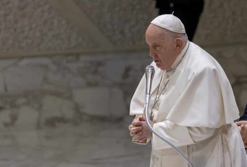 Pope Francis prays at his weekly general audience in the Vatican's Paul VI Audience Hall Nov. 29, 2023. At the beginning of the audience, he explained he still was suffering from the flu and so would have an aide read his catechesis. (CNS photo/Pablo Esparza)