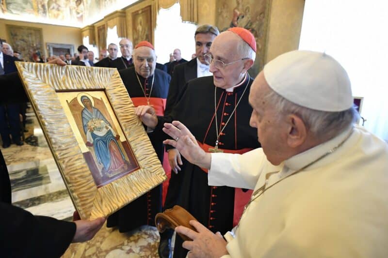 Pope Francis blesses an icon of Mary holding the city of Jerusalem in her lap during a meeting with members of the Equestrian Order of the Holy Sepulchre of Jerusalem in the Apostolic Palace at the Vatican Nov. 9, 2023. At the right is Cardinal Fernando Filoni, grand master of the order. (CNS photo/Vatican Media)