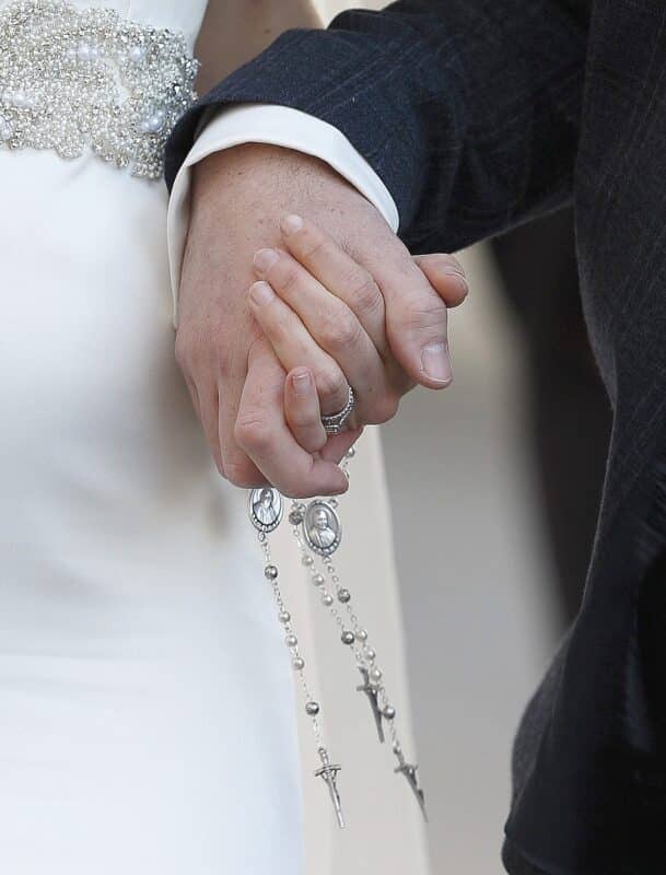 A newly married couple hold rosaries in their hands as they leave Pope Francis' general audience in St. Peter's Square at the Vatican in this Feb. 24, 2016, file photo. In his prayer intention for the month of June, the pope prayed for young couples who answer the vocational call to marriage, which is "a challenging journey, at times difficult, sometimes even confrontational, but it is worth the risk." (CNS photo/Paul Haring)