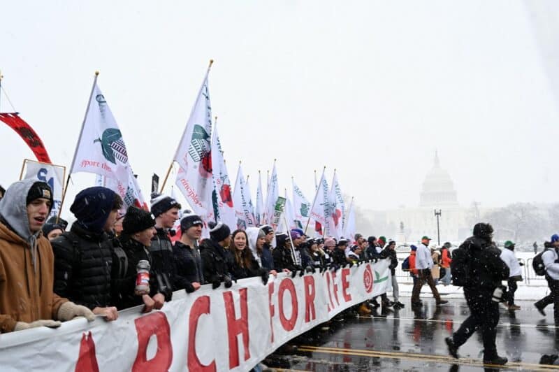 Pro-life demonstrators carry a banner past the U.S. Supreme Court building while participating in the 51st annual March for Life in Washington Jan. 19, 2024. (OSV News photo/Leslie E. Kossoff)
