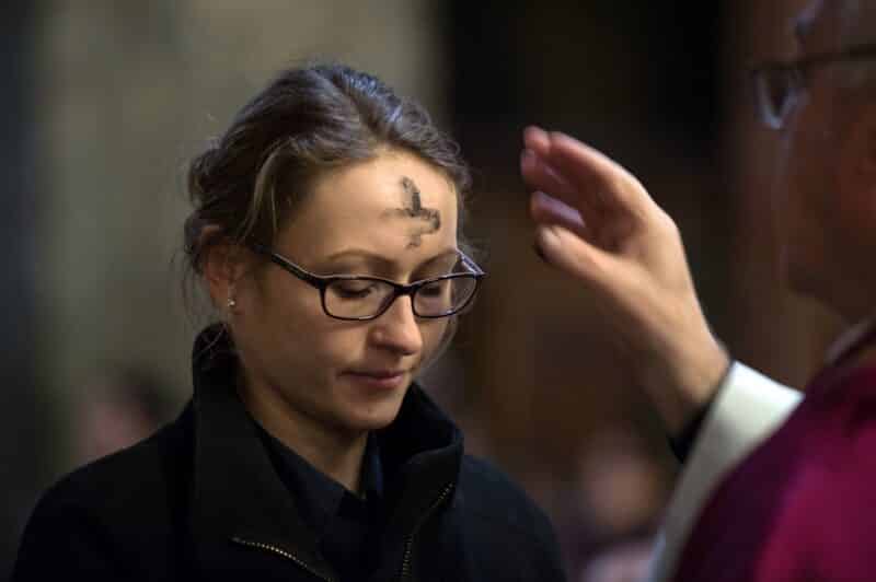 A woman is pictured in a file photo receiving ashes during Ash Wednesday Mass. Ash Wednesday falls on Valentine's Day in 2024. (OSV News photo/Marcin Mazur, Catholic Church England Wales)